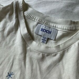 KOCH “joy maker” white cropped tee with holes in it
